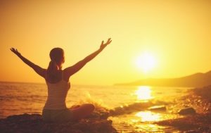 Woman Practicing Yoga at Sunset